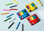 Colorful pencils and sets on a light blue background
