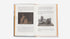 Open book with text and images of sculptures on a white background