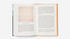 Open book with text and abstract color swatches on a white background