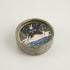 Ceramic candle holder with decorative label on a light background