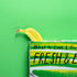 Yellow banana peeking out from a cookbook titled 'What to Cook & How' on a green background
