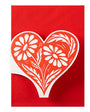 White floral heart design on a red card