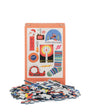 Puzzle set with pieces and packaging featuring Christmas-themed illustrations on a white background