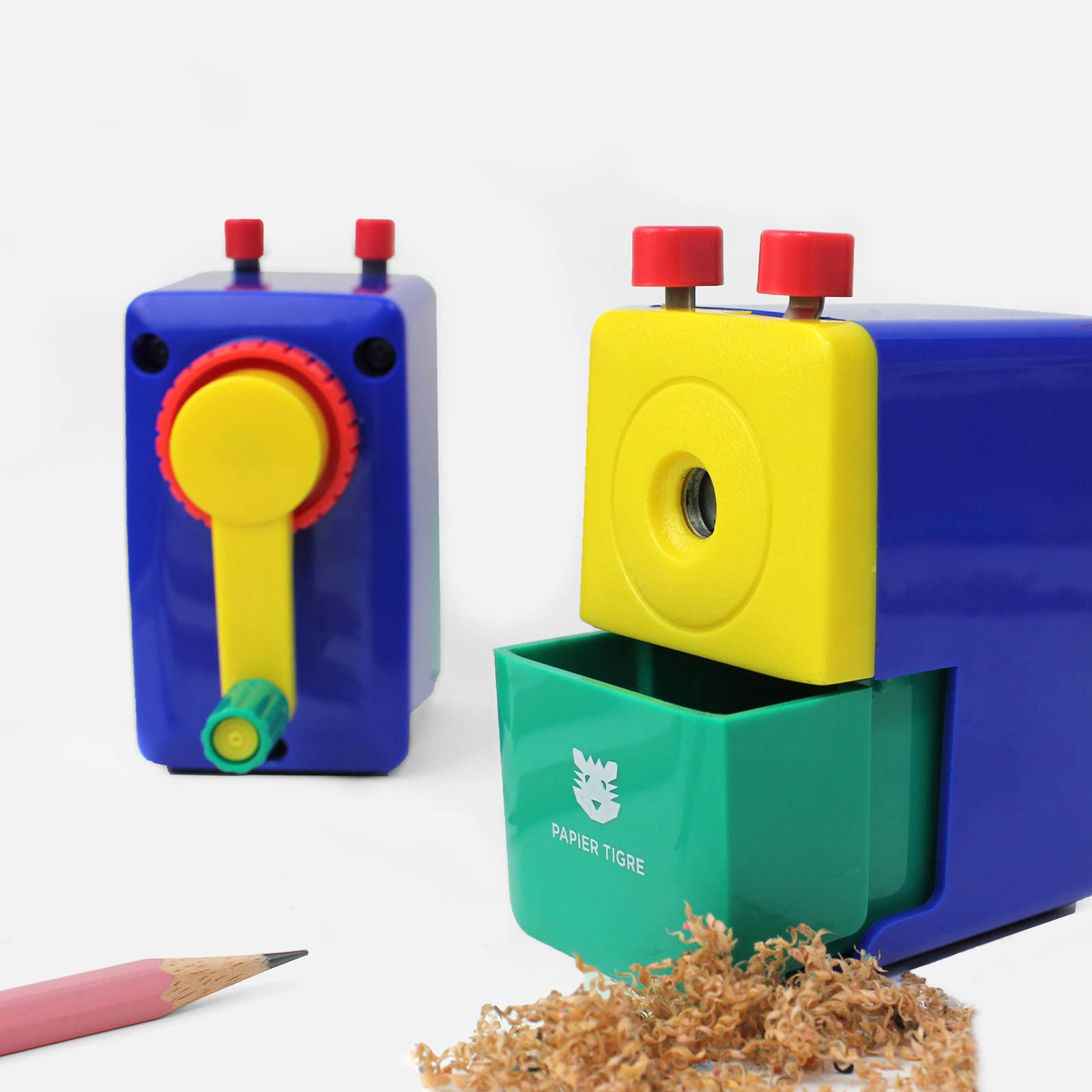 Colorful pencil sharpener with a pink pencil and shavings on a white background