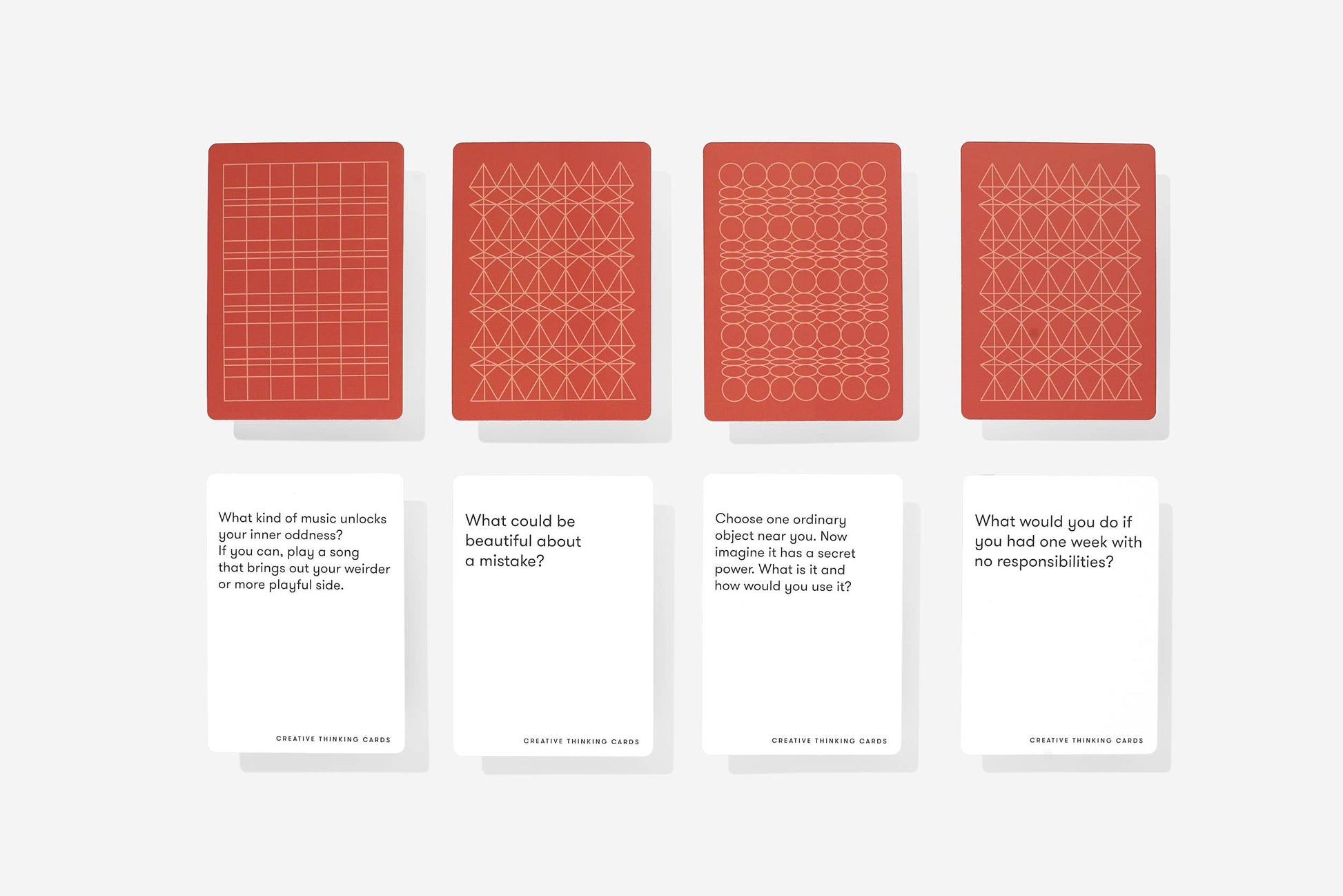 Four red card designs with geometric patterns on a white background
