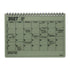 A 2027 spiral-bound notebook calendar with a light sage green cover and black printed grid layout, shown on a plain white background.