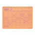 An orange 2027 spiral-bound desk calendar with pink printed grid lines and handwritten notes in purple ink, shown on a white background.