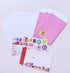 A stationery set arranged on a light background, including lined paper envelopes, pink card sleeves, sticker sheets with colorful icons, and a white letterhead card with a red checkered border.
