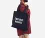 Person wearing a black tote bag with 'EMOTIONAL BAGGAGE' text on a white background