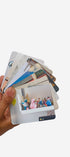 Hand holding a stack of photo cards with images on a white background