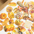 Assorted pastries on a white surface with a cardboard box in the background