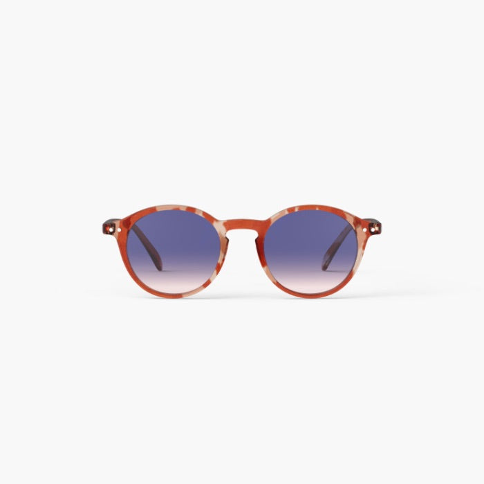Round sunglasses with a translucent reddish-brown acetate frame and blue gradient lenses, shown against a plain white background.