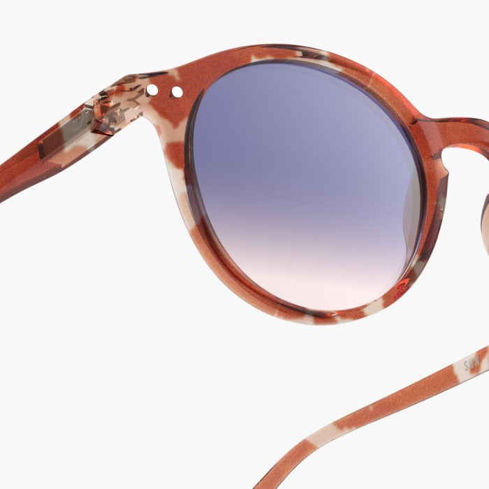Sunglasses with tortoiseshell frame and gradient lens on a white background