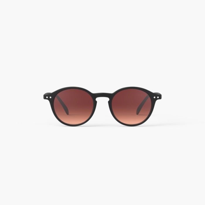 Round sunglasses with a matte black frame and warm brown gradient lenses, shown against a plain white background.