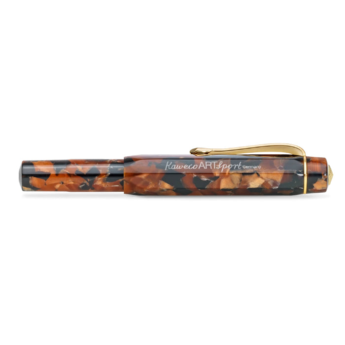 A Kaweco ART Sport pen with a marbled brown and black resin body and gold-tone metal clip, shown horizontally against a plain white background.