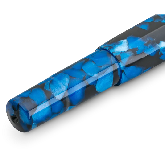 A close-up of a pen barrel with a glossy blue and black marbled pattern, shown diagonally on a white background.