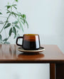 Kinto Sepai Amber Mug on a table