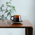 Kinto Sepai Amber Mug on a table