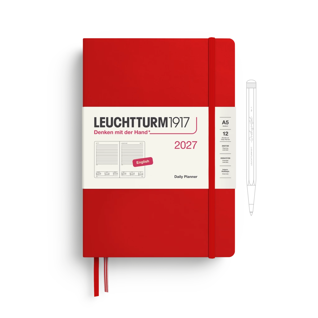 A red Leuchtturm1917 2027 daily planner with a white paper band around the middle, shown closed with a red ribbon bookmark. A white pen is pictured to the right as an included accessory on a clean white background.