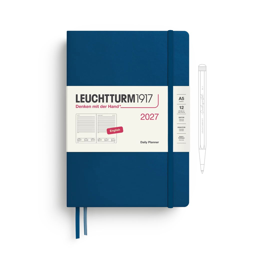 A Leuchtturm1917 2027 daily planner in indigo blue with a white paper band around the middle, shown on a white background with a pen illustration to the right.