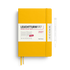 A Leuchtturm1917 2027 daily planner in a bright yellow hardcover, shown closed with a white paper band around the middle and two yellow ribbon bookmarks. A thin pen outline is visible to the right on a clean white background.