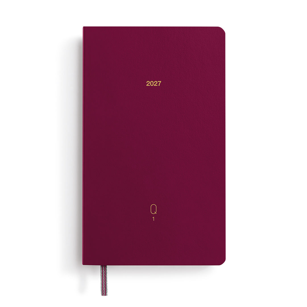 Maroon notebook with '2027' printed on it, on a white background