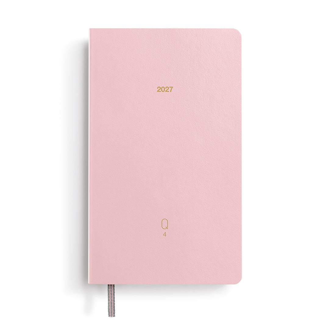 Pink planner with '2027' printed on it on a white background