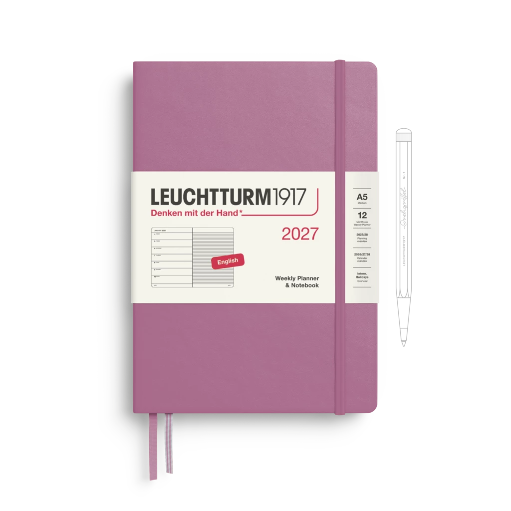 A Leuchtturm1917 2027 weekly planner in a dusty purple/magenta color, shown with its white paper band and a white pen on a clean white background.