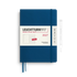 A Leuchtturm1917 2027 weekly planner and notebook in navy blue with a white paper band, shown alongside a white pen on a clean white background.