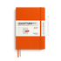 An orange Leuchtturm1917 2027 weekly planner and notebook with a white front label, shown closed with an orange ribbon bookmark. A white pen outline is visible to the right on a clean white background.
