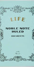 Notebook with decorative cover and 'Noble Note' text on a light blue background