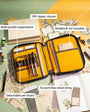 Yellow and brown organiser with pen board and stationery items on a green surface