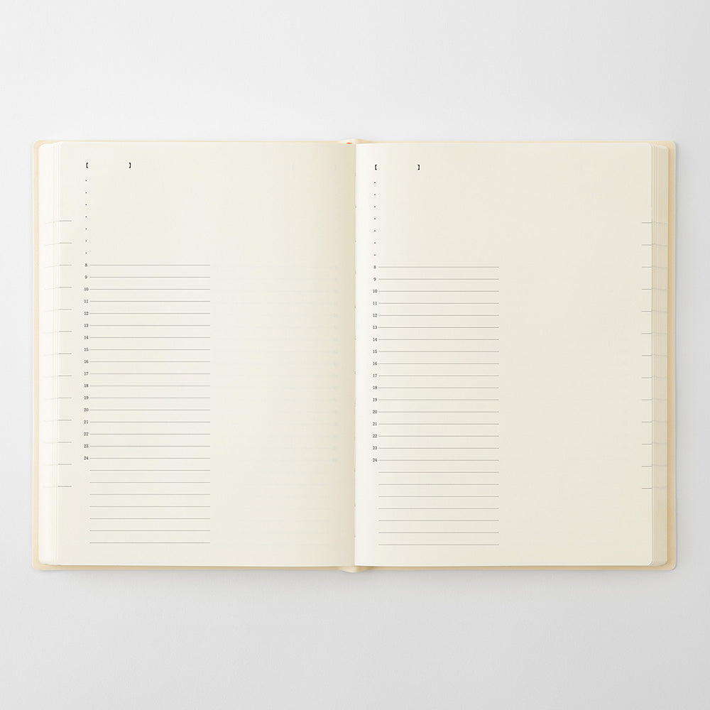 An open cream-colored notebook with lined pages, photographed flat against a light gray background.