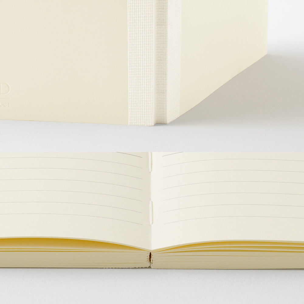 A cream-colored lined notebook shown both closed and open, highlighting the lined pages and spine texture against a clean white background.