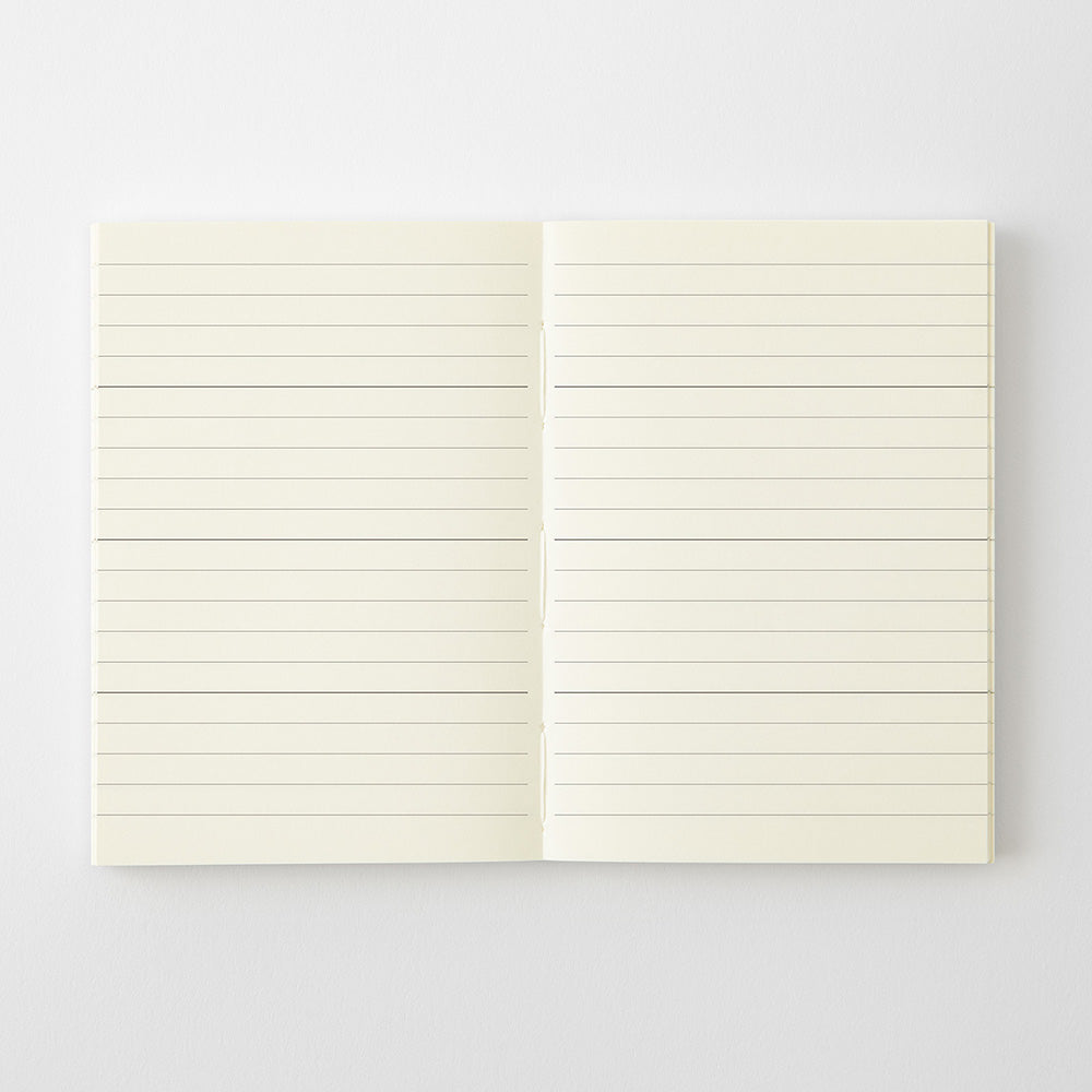 An open cream-colored lined notebook or journal, showing two blank pages with horizontal ruled lines, set against a clean white background.