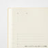 A close-up of a cream-colored daily journal page with black printed text and horizontal lines for writing, set against a clean white background.
