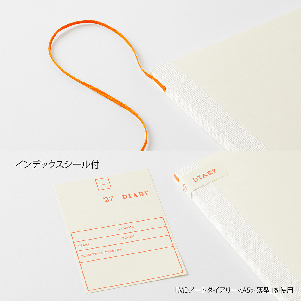 An off-white hardcover notebook or journal shown on a white background, with an orange loop tab, a small orange-red 'DIARY' label, and an index sticker sheet with Japanese text. The notebook cover has a subtle woven texture.