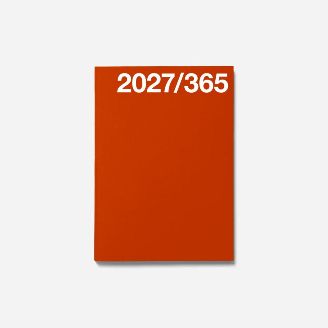 A minimalist orange planner or notebook cover with the white text '2027/365' printed at the top, shown on a light gray background.
