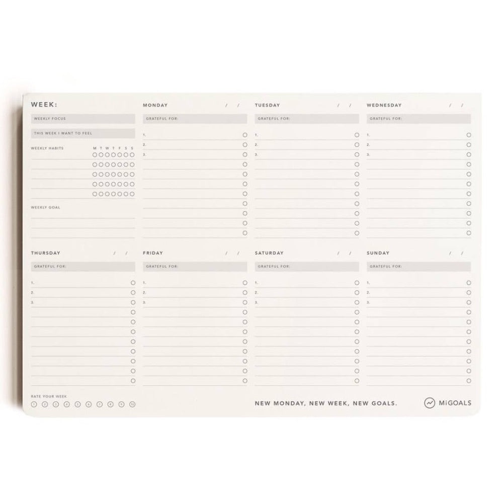 A beige weekly desk pad with a 7-day spread, including Monday to Saturday, with Sunday being a new weekly goal section.