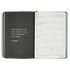 Open planner with a quote on the left page and a goal-setting layout on the right.