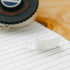 White rubber stamp with 'LACH' branding on a wooden surface