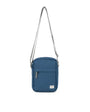 Blue crossbody bag with a strap on a white background