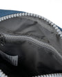 Close-up of a blue and gray bag with a zipper, showing the interior.