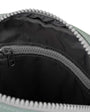 Close-up of a zipper on a pewter and black bag with a white border.