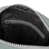 Close-up of a zipper on a pewter and black bag with a white border.