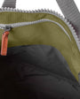interior of moss coloured backpack in front of a white background