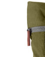 zip close up of moss coloured backpack in front of a white background