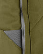 close up moss coloured backpack in front of a white background
