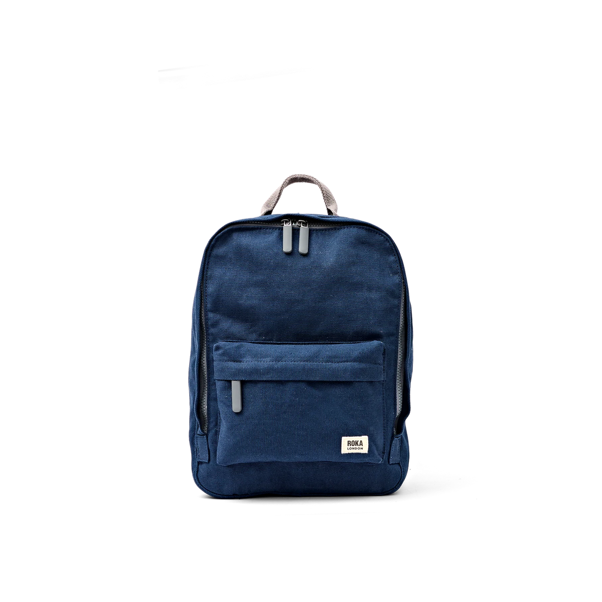 A navy blue canvas backpack with a top carry handle, a front zippered pocket, and a small white rectangular brand patch near the bottom right corner, shown against a plain white background.