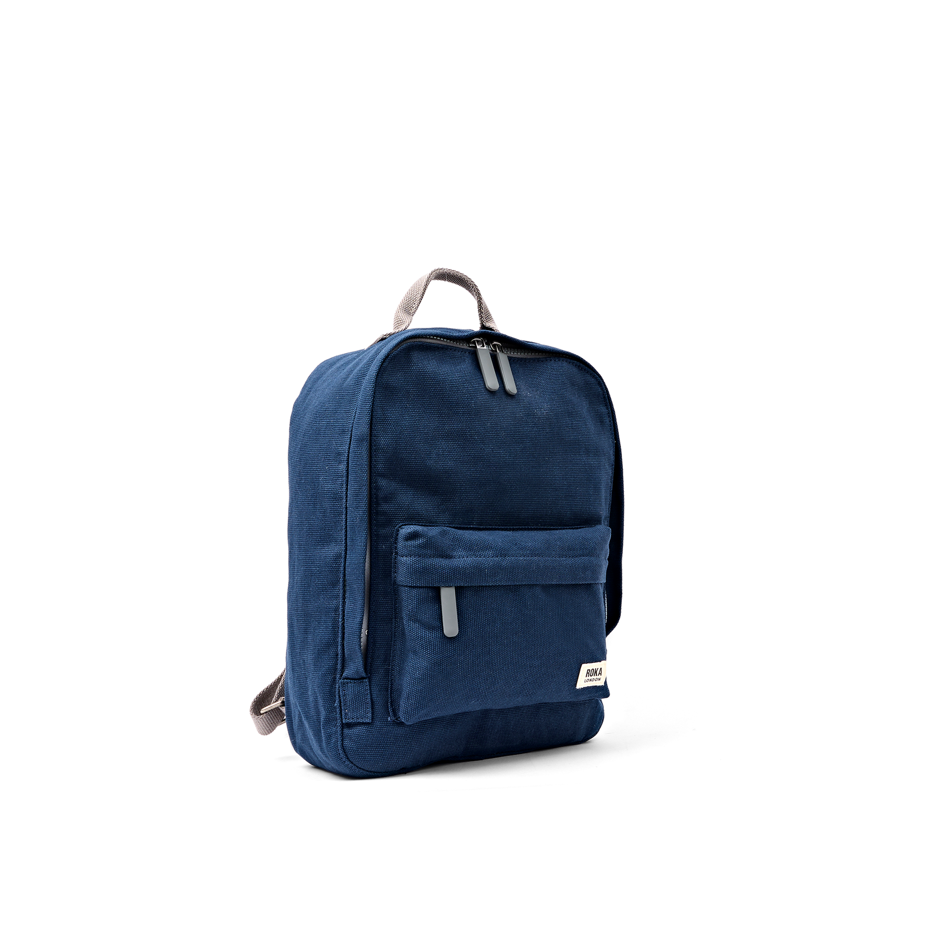 A navy blue canvas backpack with gray zipper pulls and a small white brand label on the front pocket, shown from a three-quarter angle on a white background.